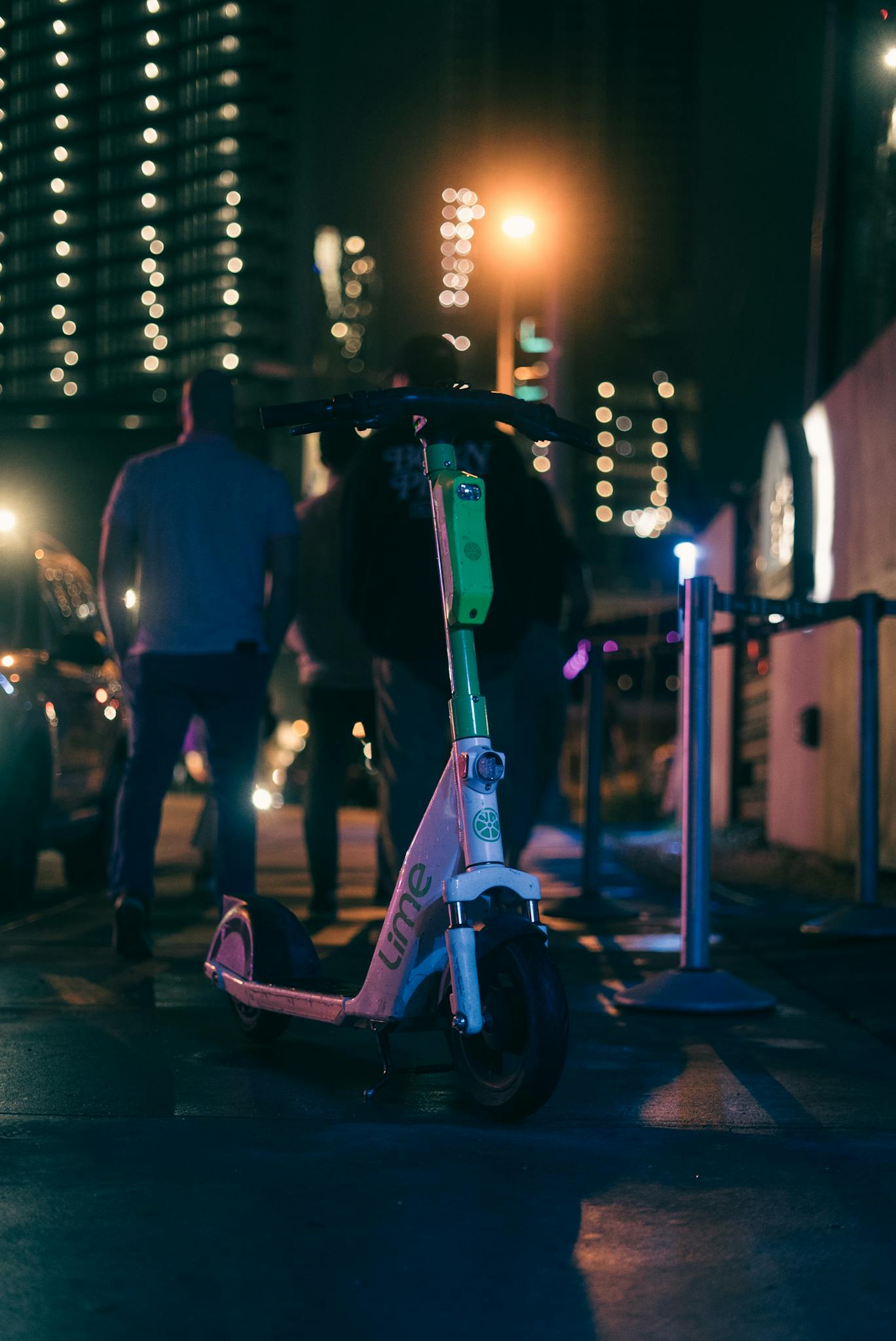 Electric Scooter and People on Sidewalk behind